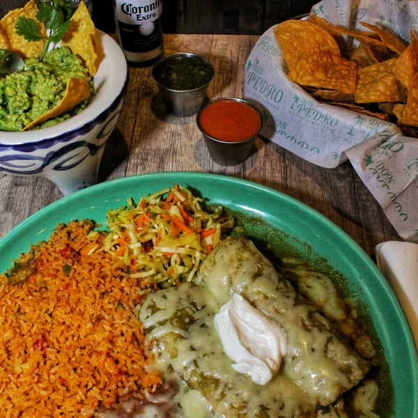 Don Pedro Mexican Restaurant's enchiladas with rice, slaw, guacamole, chips, salsa, and a Corona Extra.